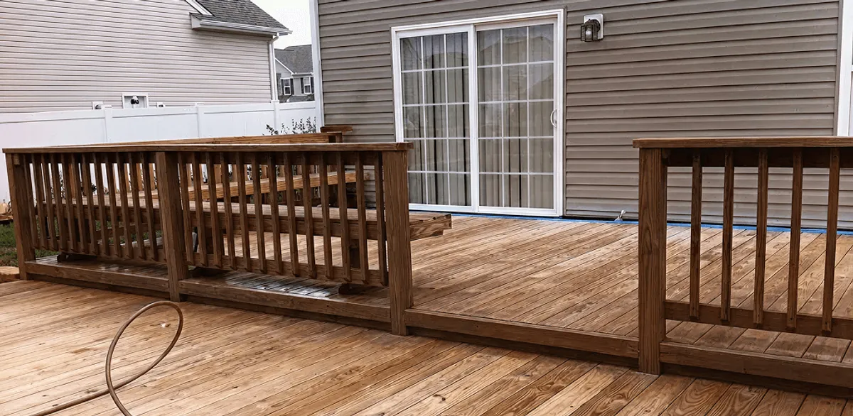Deck sealing service protecting a backyard wood deck and railings in Springfield, MO