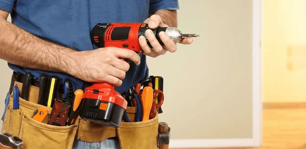 Handyman holding a power drill for home repairs and installations in Springfield, MO
